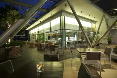 a restaurant with tables and chairs in a building at Meta @ Swiss Garden Residence KL Bukit Bintang in Kuala Lumpur