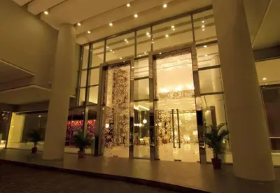 a large building with large glass windows and plants at Meta @ Swiss Garden Residence KL Bukit Bintang in Kuala Lumpur