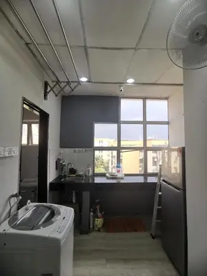 a kitchen with a stove and a sink in a room at Blue house KL Homestay in Kuala Lumpur