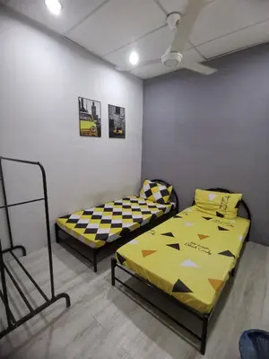 two beds in a room with a ceiling at Blue house KL Homestay in Kuala Lumpur