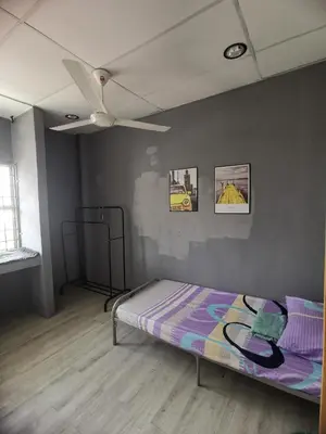 a bedroom with a bed and a ceiling fan at Blue house KL Homestay in Kuala Lumpur