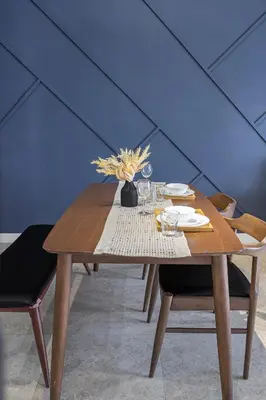 a wooden table with a vase of flowers on it at Anggun Residence Serviced Suites By BedStay in Kuala Lumpur