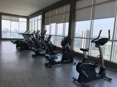 a gym with a row of treadmills and exercise bikes at TR Residence 3R2B Serviced Apt 5-6pax HKL,IJN,PWTC KL in Kuala Lumpur