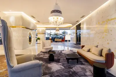 a lobby with couches and chairs and a chandelier at Arte Mont Kiara Hotel Suite in Kuala Lumpur