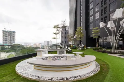 a park with a table and benches in a city at Arte Mont Kiara Hotel Suite in Kuala Lumpur