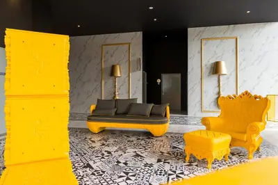 a living room with two yellow chairs and a couch at Arte Mont Kiara Hotel Suite in Kuala Lumpur