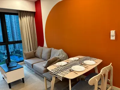 a living room with a table and a couch at The Ooak Suites by Bamboo Hospitality in Kuala Lumpur