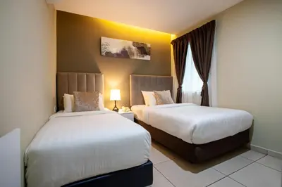 a hotel room with two beds and a window at Raissa Boutique Hotel in Kuala Lumpur