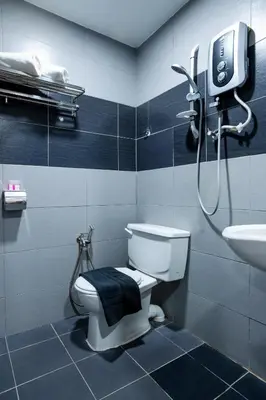 a bathroom with a shower and a toilet and a sink at Raissa Boutique Hotel in Kuala Lumpur