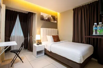 a hotel room with a bed and a desk at Raissa Boutique Hotel in Kuala Lumpur