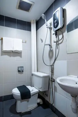a bathroom with a shower and a toilet and a sink at Raissa Boutique Hotel in Kuala Lumpur