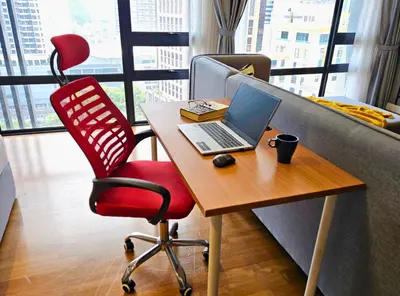 a desk with a laptop and a red chair at Anggun Homestay King Bed Studio KL City Bukit Bintang by Cloud Host in Kuala Lumpur