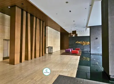 a lobby of a building with red chairs at Anggun Homestay King Bed Studio KL City Bukit Bintang by Cloud Host in Kuala Lumpur