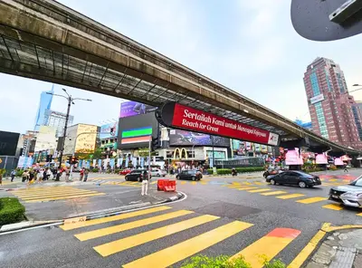 a busy city street with cars and people on a crosswalk at Anggun Homestay King Bed Studio KL City Bukit Bintang by Cloud Host in Kuala Lumpur
