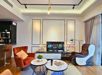 a living room with two chairs and a tv at Anggun Homestay King Bed Studio KL City Bukit Bintang by Cloud Host in Kuala Lumpur