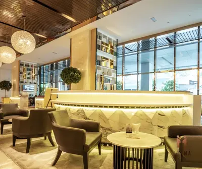 a lobby of a hotel with chairs and tables at The Platinum KLCC in Kuala Lumpur