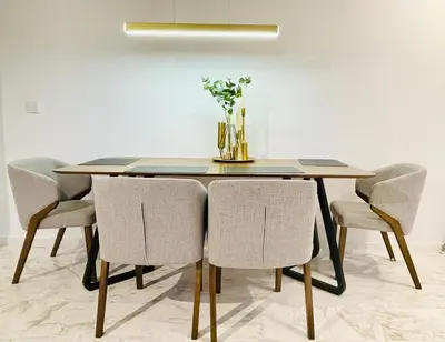 a dining room table with chairs and a vase of flowers at EatonResidences KLCC by MAH in Kuala Lumpur