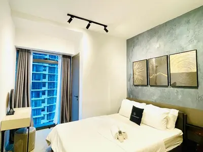 a bedroom with a white bed and a window at EatonResidences KLCC by MAH in Kuala Lumpur