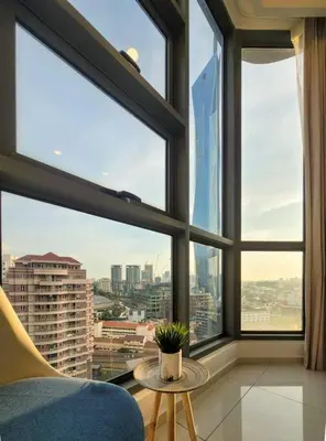 a room with large windows with a chair and a table at The Robertson @ 118 Tower Super View in Kuala Lumpur