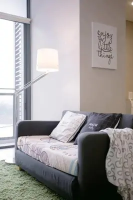 a black couch in a living room with a lamp at Stylish & Cozy TTDI Ascencia Studio FREE Parking in Kuala Lumpur