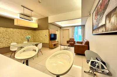 a kitchen and living room with chairs and a table at A Cozy High Floor Suasana KL Bkt Bintang in Kuala Lumpur