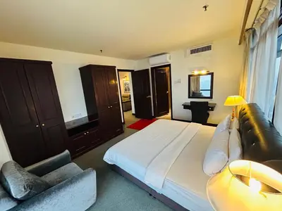 a large bedroom with a large bed and a couch at TWO BEDROOM SUITES at TIMES SQUARE KL in Kuala Lumpur