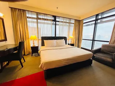 a bedroom with a bed and a desk and a chair at TWO BEDROOM SUITES at TIMES SQUARE KL in Kuala Lumpur