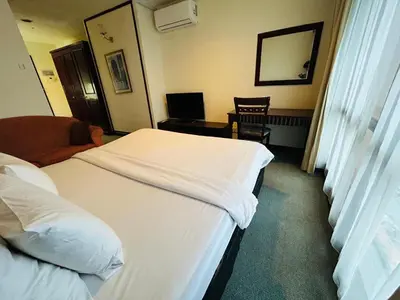a hotel room with two beds and a desk at TWO BEDROOM SUITES at TIMES SQUARE KL in Kuala Lumpur