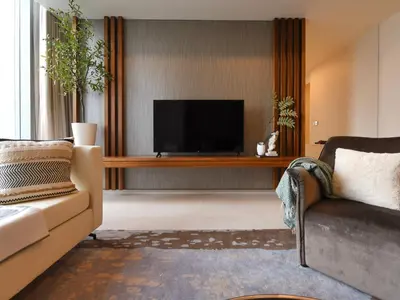 a living room with a television and a couch at Tropicana The Residences - KLCC VIEW Luxury Apartment Collections in Kuala Lumpur