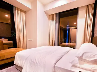 a bedroom with a large white bed and a mirror at Tropicana The Residences - KLCC VIEW Luxury Apartment Collections in Kuala Lumpur