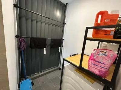 a closet with a black door and a shelf at Eaton Residences in Kuala Lumpur