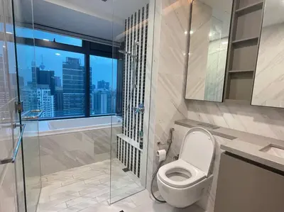 a bathroom with a toilet and a glass shower at Eaton Residences in Kuala Lumpur