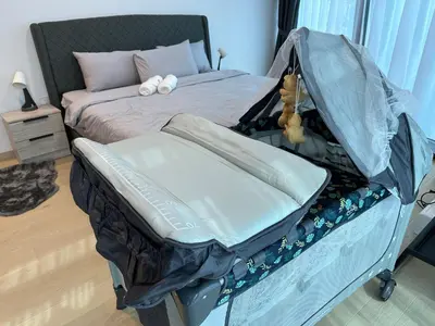 a bedroom with a bed with a teddy bear on it at Eaton Residences in Kuala Lumpur