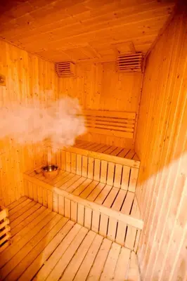 an inside of a wooden sauna with smoke coming out at Eaton Residences in Kuala Lumpur