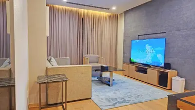a living room with a flat screen tv on a wall at Luxurious stay in 188 Fraser Residence Suite in Kuala Lumpur