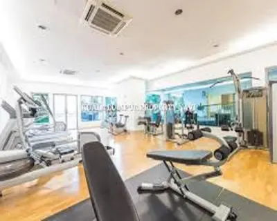 a gym with treadmills and machines in a room at Suasana Suites KLCC by Grand Royal in Kuala Lumpur
