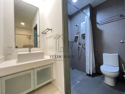 a bathroom with a toilet and a sink and a shower at Mercu Summer Suites in Kuala Lumpur