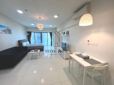 a living room with a couch and a table at Mercu Summer Suites in Kuala Lumpur