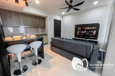 a living room with a bar and a flat screen tv at Datum Jelatek by Plush in Kuala Lumpur