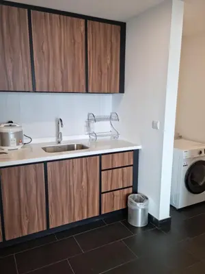 a kitchen with a sink and a washing machine at Una Residence by Maya in Kuala Lumpur