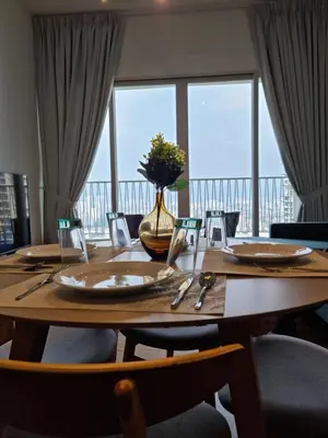 a wooden table with chairs and a vase of flowers on it at Una Residence by Maya in Kuala Lumpur