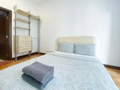 a bedroom with a large bed with a blue blanket at Awesomestay Apartment walk to PWTC near to KLCC in Kuala Lumpur