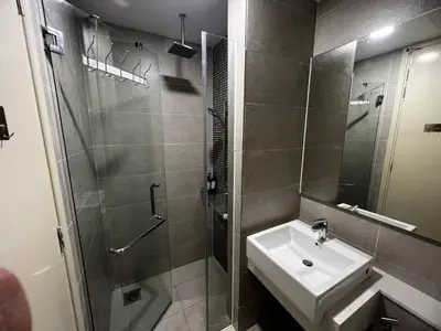 a bathroom with a sink and a shower at The Ooak Suite in Kuala Lumpur