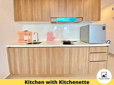 a kitchen with wooden cabinets and a kitchen with a sink at Pacific Homestay Petaling Jaya @ 1 Utama and Universiti Malaya in Petaling Jaya