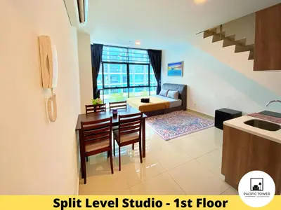 a kitchen and living room with a table and chairs at Pacific Homestay Petaling Jaya @ 1 Utama and Universiti Malaya in Petaling Jaya
