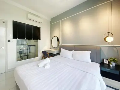 a bedroom with a large white bed with white pillows at Arte Mont Kiara By Awesomestay in Kuala Lumpur