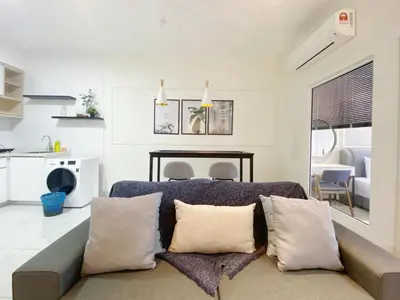 a living room with a couch with pillows at Arte Mont Kiara By Awesomestay in Kuala Lumpur