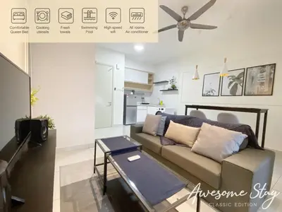 a living room with a couch and a table at Arte Mont Kiara By Awesomestay in Kuala Lumpur