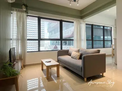 a living room with a couch and large windows at Arte Plus Ampang By Awesomestay in Kuala Lumpur