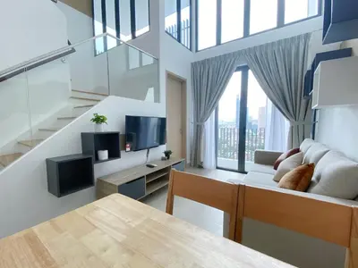 a living room with a couch and a tv at The Colony By Infinitum By Awesomestay in Kuala Lumpur